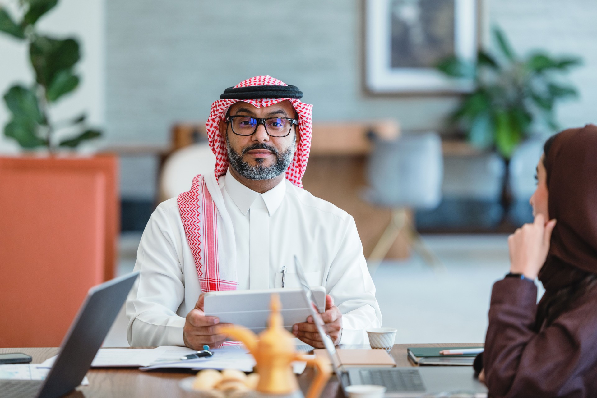 Confident Mid Adult Arabic Businessman Leading Meeting in Modern Office